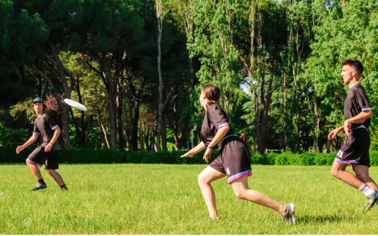 Players on a field, passing a frisbee with teamwork and sportsmanship. Fair play and respect are evident in their actions